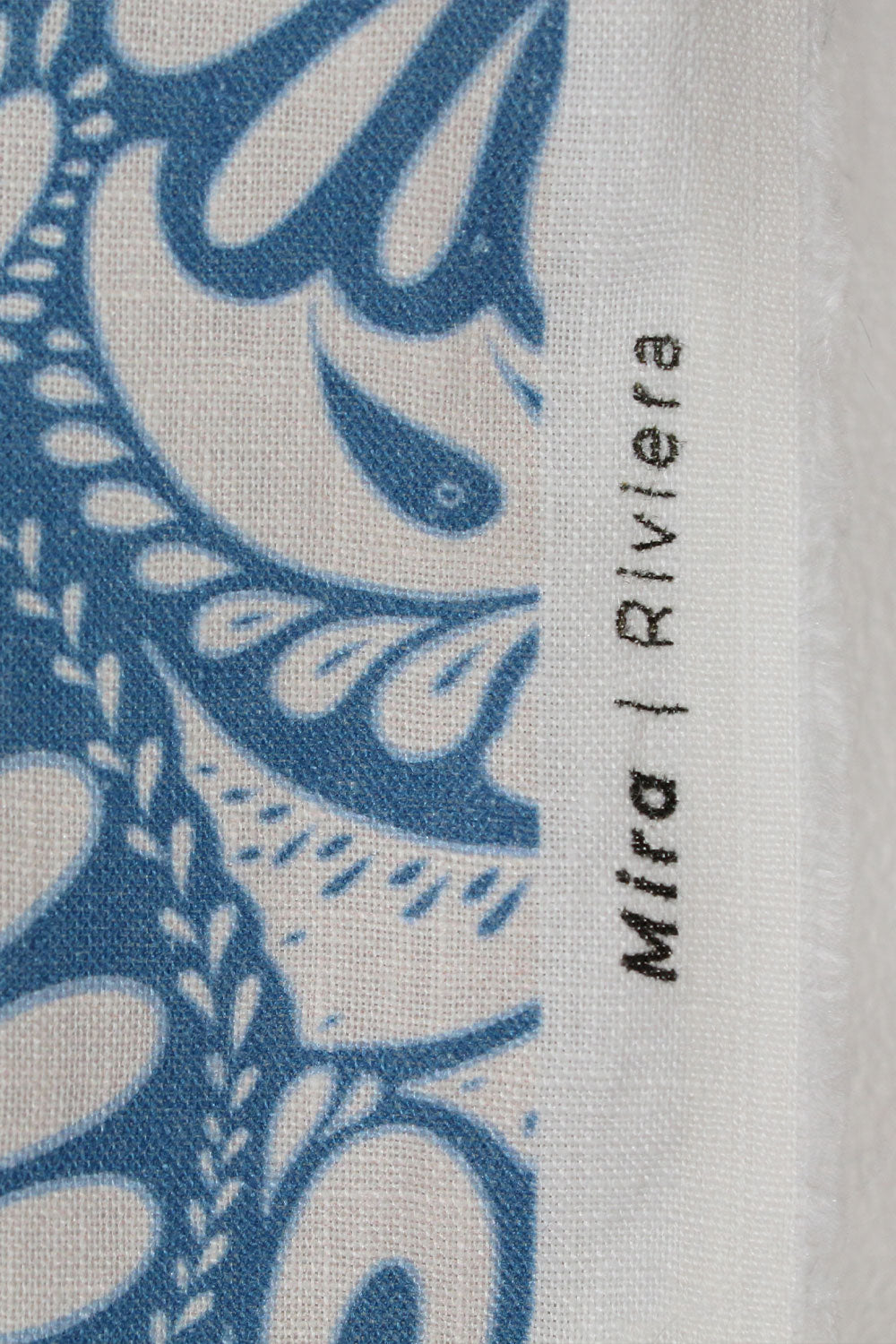 Textile with blue and white pattern and 'Mira Riviera' branding.