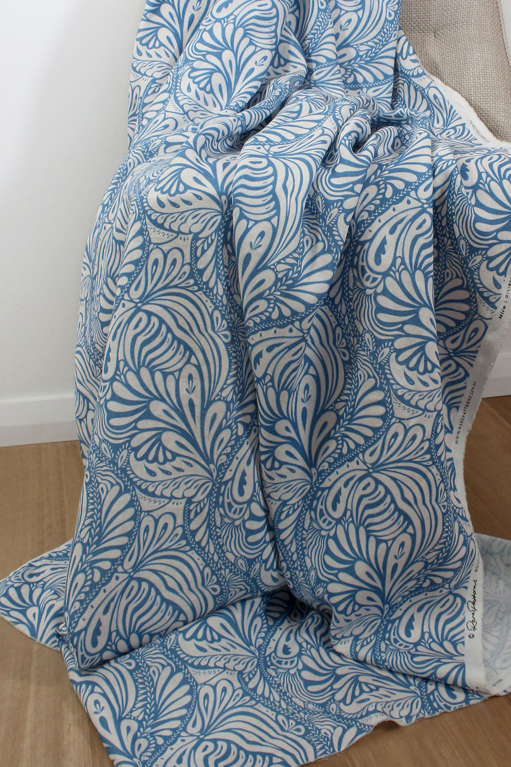Blue and white patterned blanket draped over a chair.